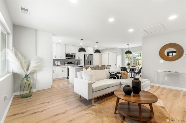 3061 S Glencoe St, Denver, CO 80222 - living area featuring light wood-style flooring and recessed lighting