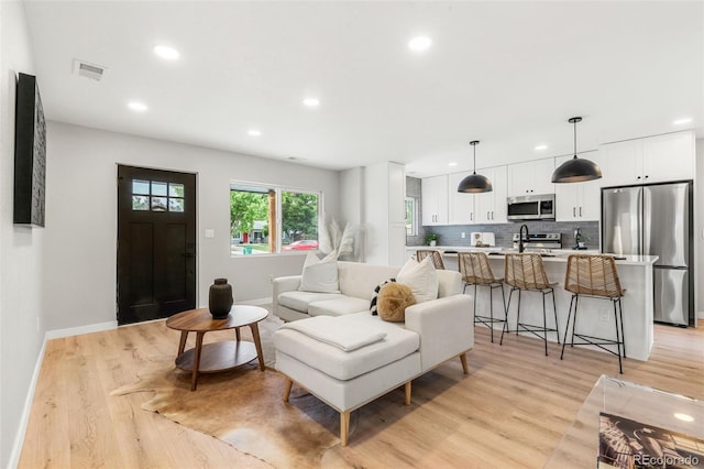 3061 S Glencoe St, Denver, CO 80222 - living area with light wood finished floors and recessed lighting