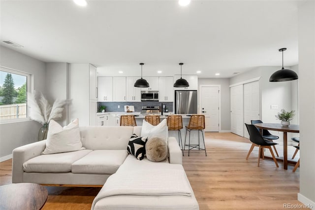 3061 S Glencoe St, Denver, CO 80222 - living room with recessed lighting and light wood finished floors