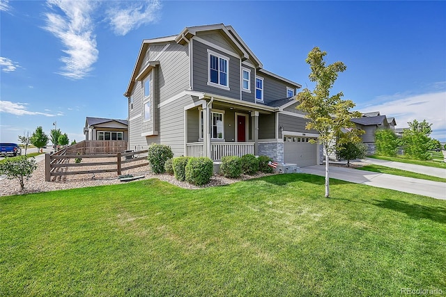 craftsman-style home with covered porch, a front lawn, and a garage