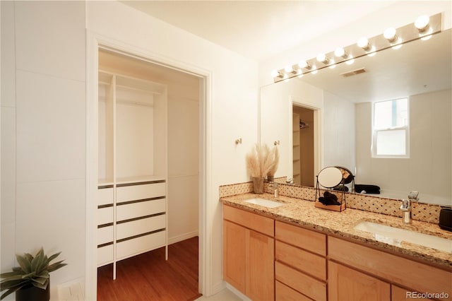 bathroom with vanity and hardwood / wood-style flooring