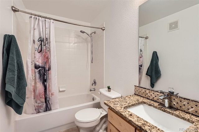 full bathroom featuring vanity, shower / bath combo with shower curtain, and toilet