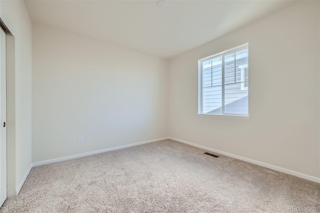 unfurnished room featuring carpet