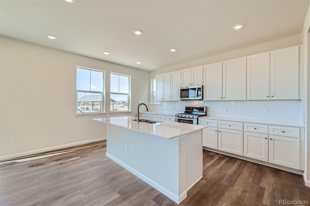 kitchen featuring white cabinetry, sink, a kitchen island with sink, and appliances with stainless steel finishes