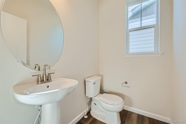 bathroom with sink, hardwood / wood-style flooring, and toilet