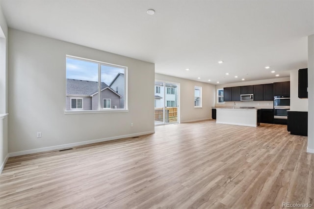 1290 Loraine Cir N, Lafayette, CO 80026 - unfurnished living room featuring light wood-style floors and recessed lighting