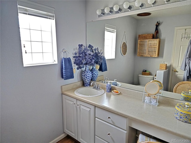 bathroom featuring toilet and vanity