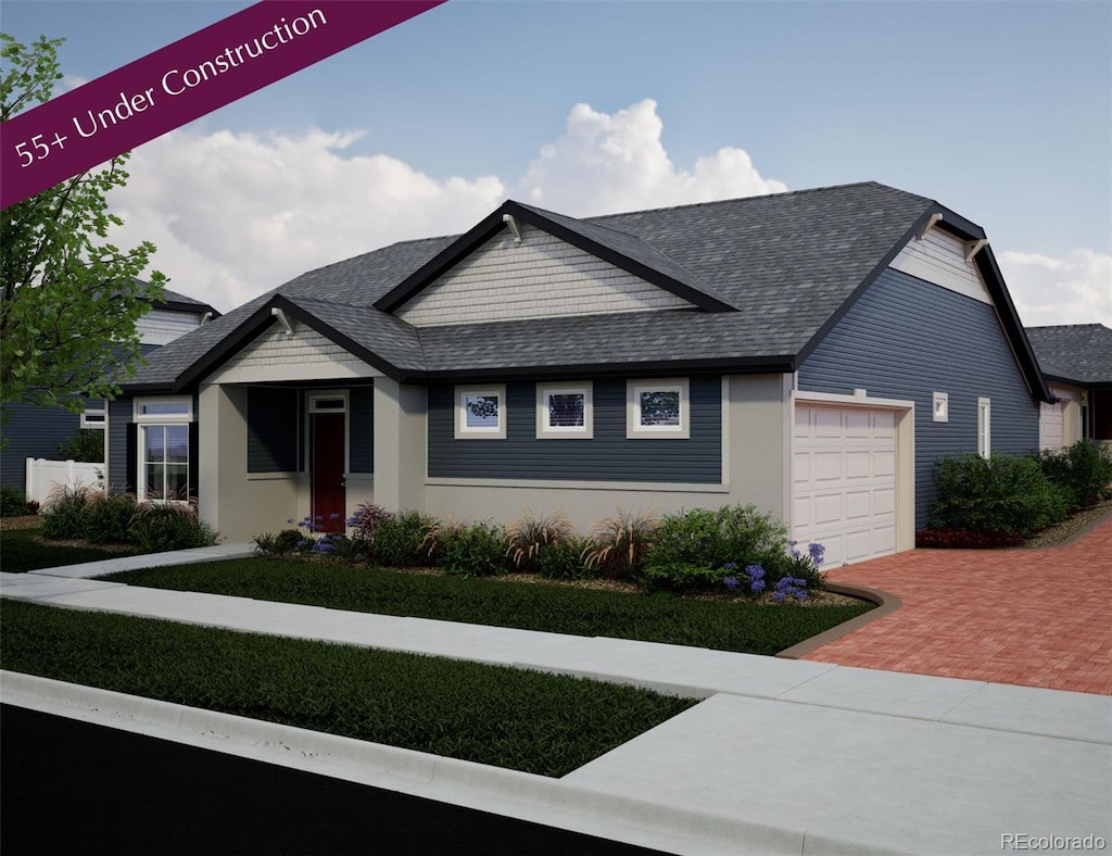 21825 E 51st Dr, Aurora, CO 80019 - view of front of home featuring an attached garage, decorative driveway, and a shingled roof