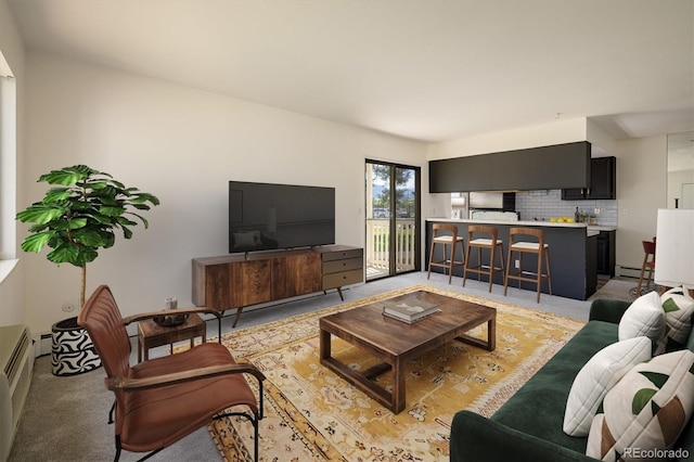 living room with light colored carpet, baseboard heating, and a baseboard radiator