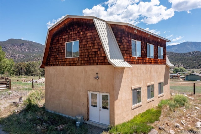 689 County Road 4, Howard, CO 81233 - view of property exterior with stucco siding, a mountain view, a standing seam roof, and a metal roof
