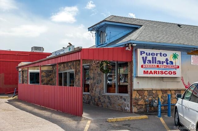 view of commercial property featuring uncovered parking