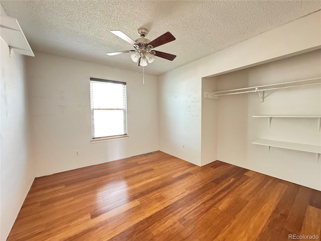 4312 S Xenon St, Morrison, CO 80465 - unfurnished bedroom featuring a textured ceiling, wood finished floors, a closet, and ceiling fan