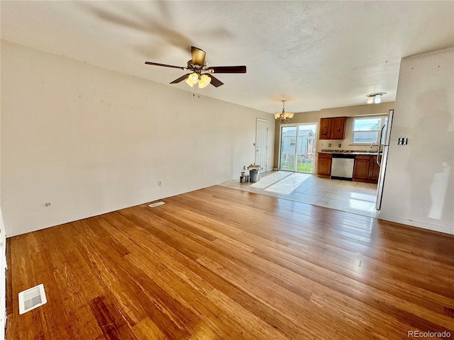 4312 S Xenon St, Morrison, CO 80465 - unfurnished living room featuring a chandelier, light wood-style flooring, and ceiling fan