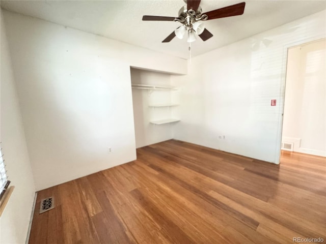 4312 S Xenon St, Morrison, CO 80465 - unfurnished bedroom with wood finished floors, a closet, and a ceiling fan