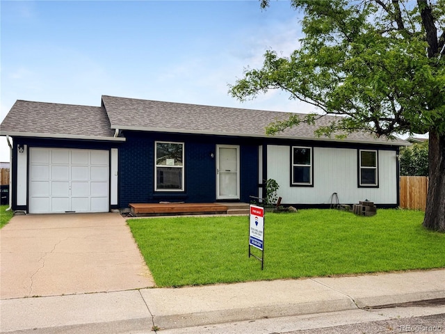 4312 S Xenon St, Morrison, CO 80465 - single story home featuring an attached garage, concrete driveway, and a shingled roof
