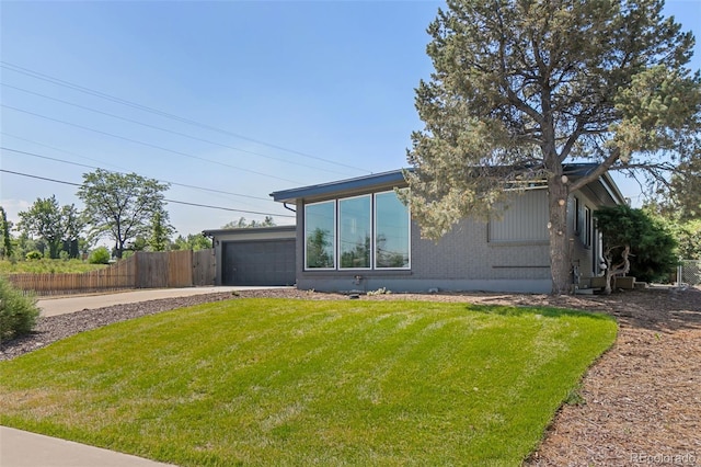 view of front of property featuring a garage and a front lawn