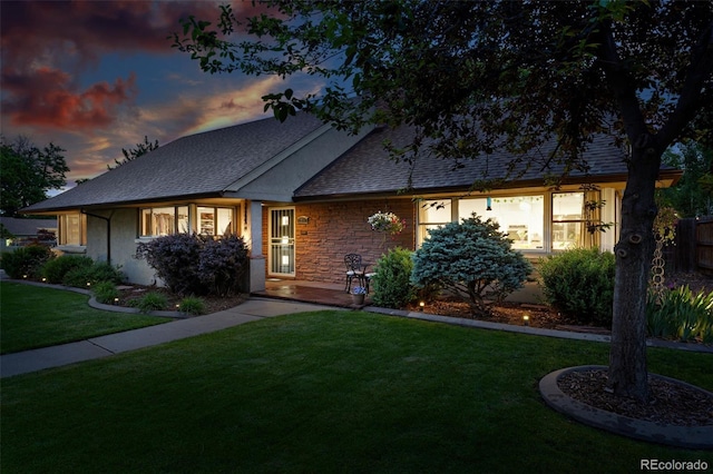 2250 N Monaco Pkwy, Denver, CO 80207 - view of front of house with a lawn, roof with shingles, and stone siding