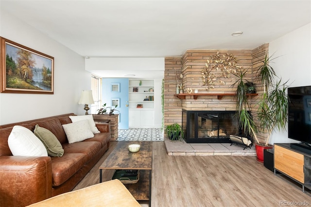 2250 N Monaco Pkwy, Denver, CO 80207 - living area with wood finished floors, a fireplace, and built in features