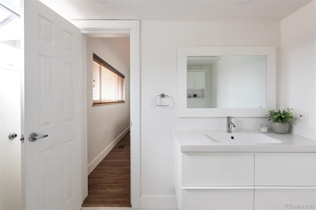2250 N Monaco Pkwy, Denver, CO 80207 - bathroom featuring vanity and wood finished floors