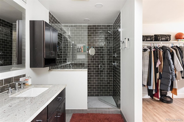 2250 N Monaco Pkwy, Denver, CO 80207 - full bath featuring a shower stall, vanity, wood finished floors, and a walk in closet