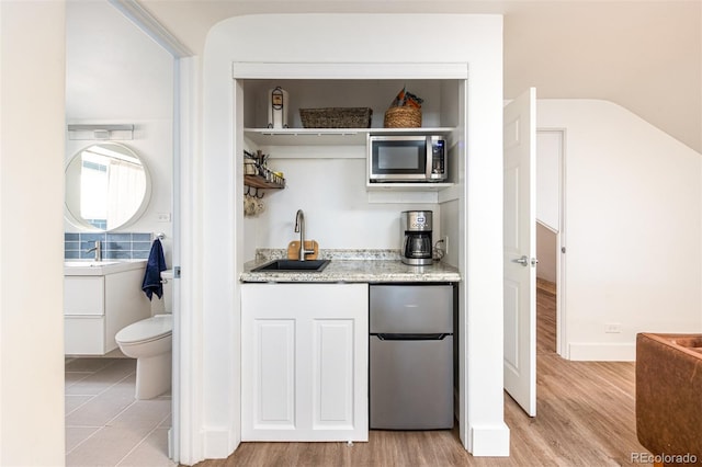 2250 N Monaco Pkwy, Denver, CO 80207 - bar with appliances with stainless steel finishes and light wood-type flooring