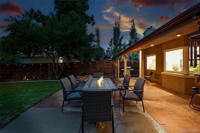 2250 N Monaco Pkwy, Denver, CO 80207 - patio terrace at dusk with an outdoor fire pit and a patio