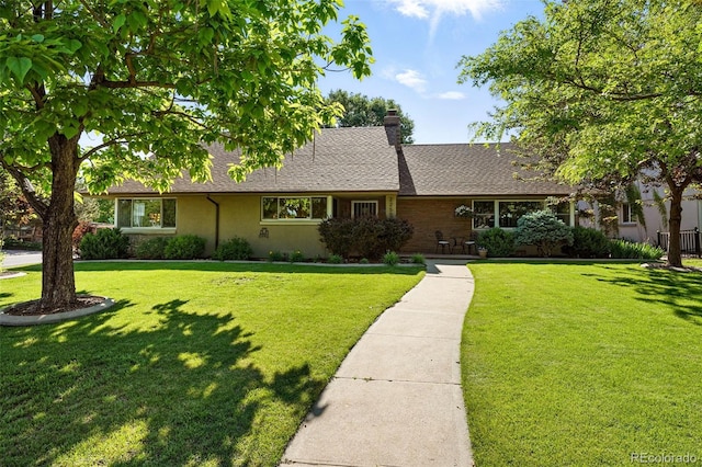 2250 N Monaco Pkwy, Denver, CO 80207 - view of front of property with a front yard, a chimney, and roof with shingles