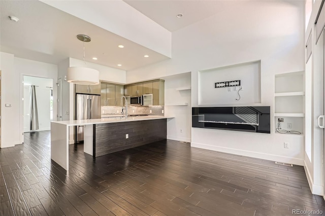 3030 N Wilson Ct Unit 3, Denver, CO 80205 - kitchen with stainless steel appliances, light countertops, dark wood-style flooring, decorative light fixtures, and recessed lighting