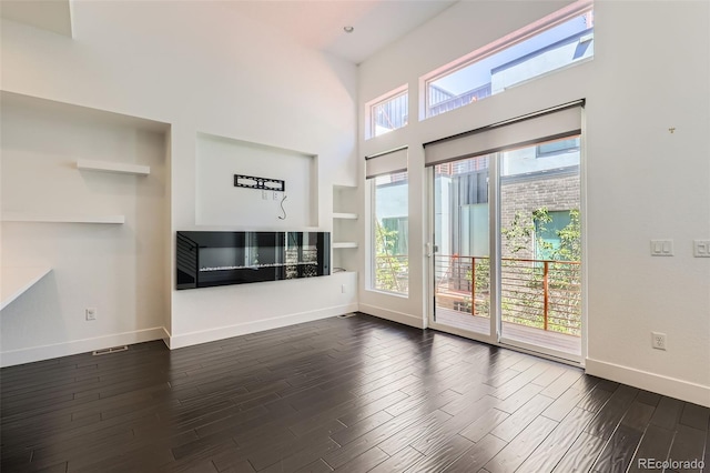 3030 N Wilson Ct Unit 3, Denver, CO 80205 - unfurnished living room with dark wood-style flooring and a high ceiling