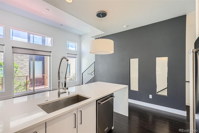 3030 N Wilson Ct Unit 3, Denver, CO 80205 - kitchen with stainless steel dishwasher, dark wood-style floors, healthy amount of natural light, and white cabinetry