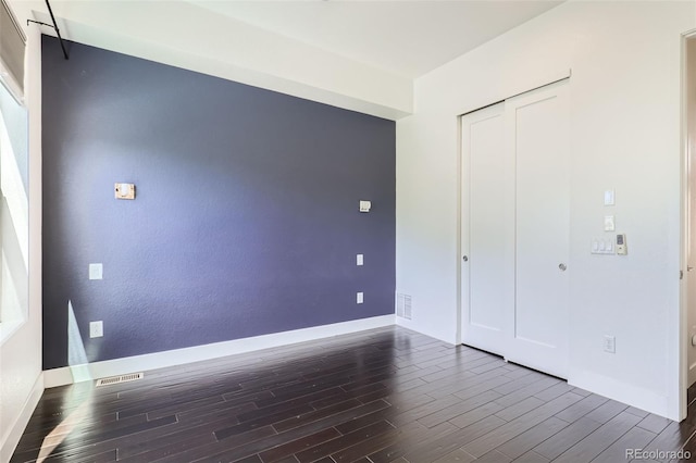 3030 N Wilson Ct Unit 3, Denver, CO 80205 - unfurnished bedroom with dark wood-type flooring and a closet