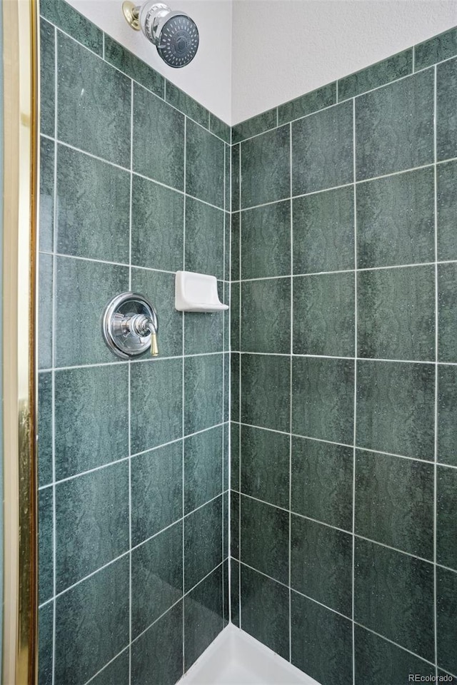 bathroom with tiled shower