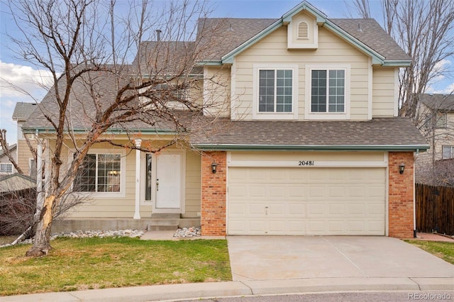 traditional-style home featuring an attached garage, a shingled roof, brick siding, and concrete driveway