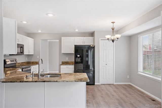 20481 E Mansfield Pl, Aurora, CO 80013 - kitchen featuring black appliances, dark stone counters, a peninsula, white cabinets, and recessed lighting