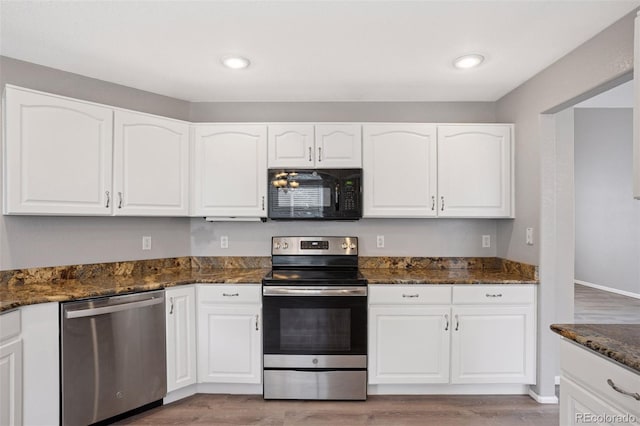 20481 E Mansfield Pl, Aurora, CO 80013 - kitchen featuring appliances with stainless steel finishes, light wood-type flooring, white cabinetry, dark stone counters, and recessed lighting
