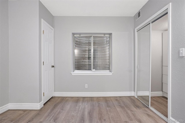 20481 E Mansfield Pl, Aurora, CO 80013 - unfurnished bedroom featuring wood finished floors and a closet