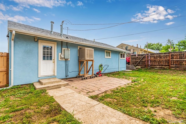5001 W Nevada Pl, Denver, CO 80219 - back of house with stucco siding, a patio, and entry steps