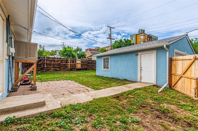 5001 W Nevada Pl, Denver, CO 80219 - fenced backyard with a patio area and an outbuilding