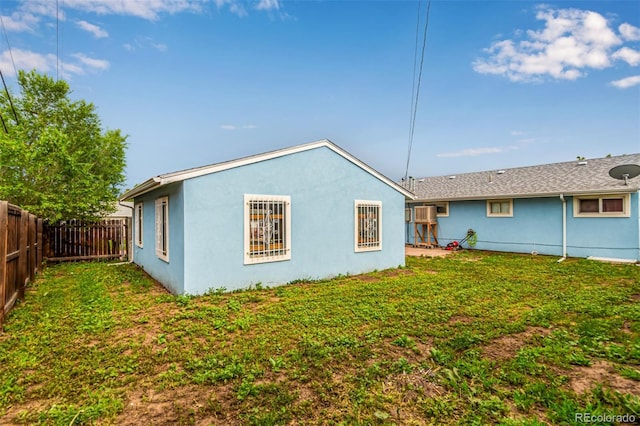 5001 W Nevada Pl, Denver, CO 80219 - back of house featuring a fenced backyard and stucco siding