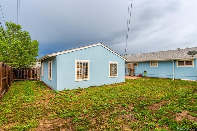 5001 W Nevada Pl, Denver, CO 80219 - rear view of property with a fenced backyard and stucco siding