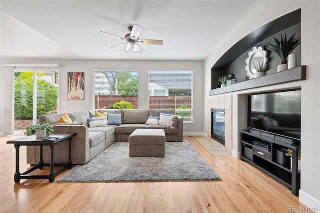 12942 Leyden St, Thornton, CO 80602 - living room with wood finished floors, ceiling fan, a fireplace, and baseboards