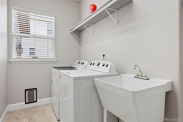 12942 Leyden St, Thornton, CO 80602 - washroom with washing machine and dryer, baseboards, and light tile patterned floors