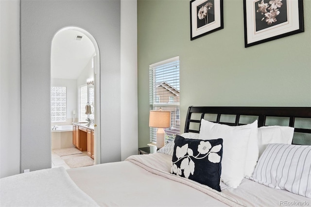 12942 Leyden St, Thornton, CO 80602 - bedroom with multiple windows, ensuite bathroom, a towering ceiling, and arched walkways