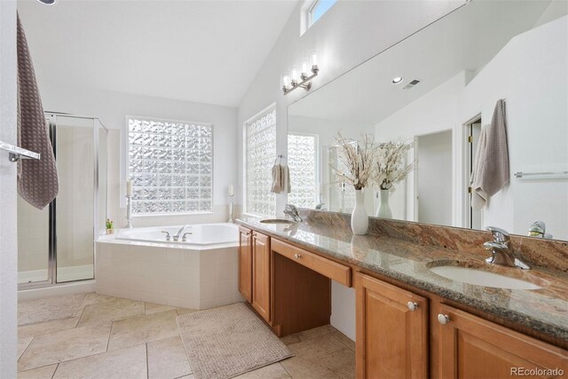 12942 Leyden St, Thornton, CO 80602 - full bath featuring a bath, double vanity, lofted ceiling, a stall shower, and tile patterned floors