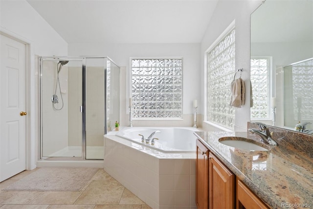 12942 Leyden St, Thornton, CO 80602 - full bathroom with vanity, a garden tub, a shower stall, and tile patterned flooring