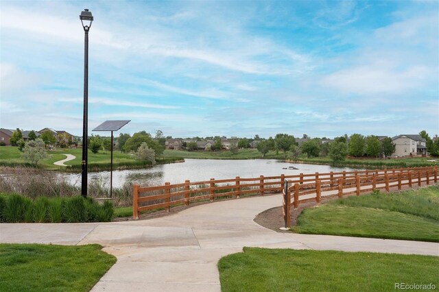 12942 Leyden St, Thornton, CO 80602 - view of community featuring a water view and curved driveway
