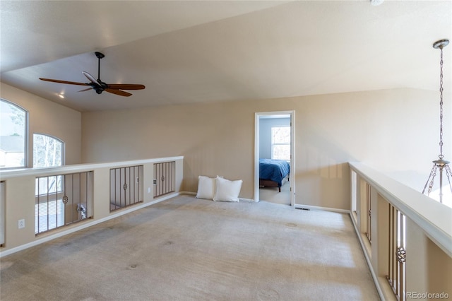 bonus room with light carpet, plenty of natural light, ceiling fan, and vaulted ceiling