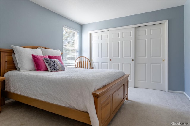 bedroom with light carpet and a closet