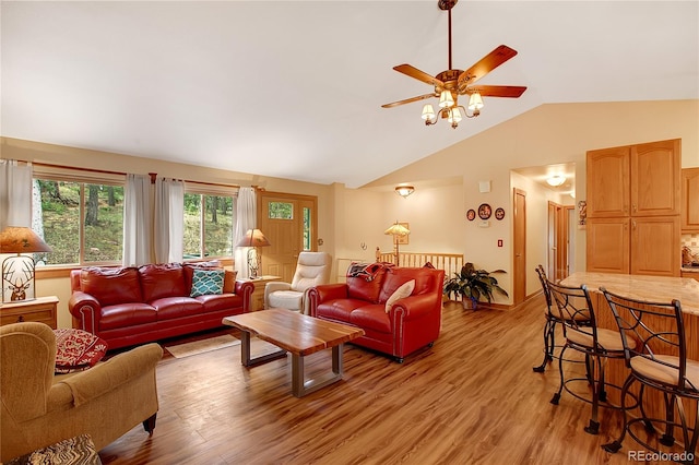 living room featuring vaulted ceiling, ceiling fan, and light hardwood / wood-style floors