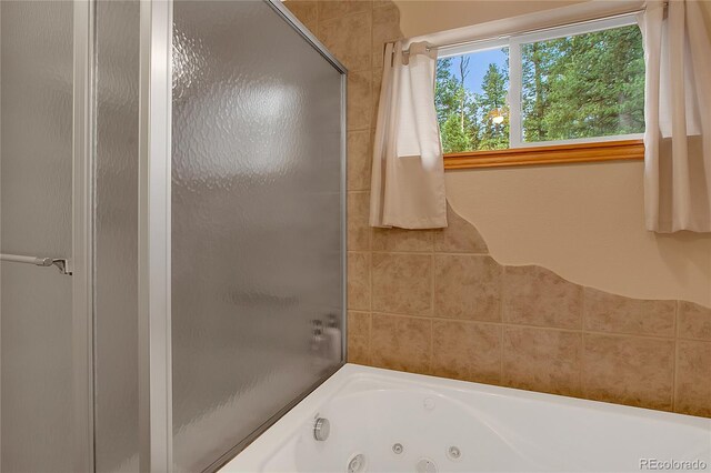 bathroom featuring plus walk in shower